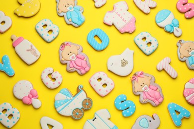 Set of baby shower cookies on yellow background, flat lay