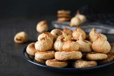 Tasty dried figs on grey table, closeup