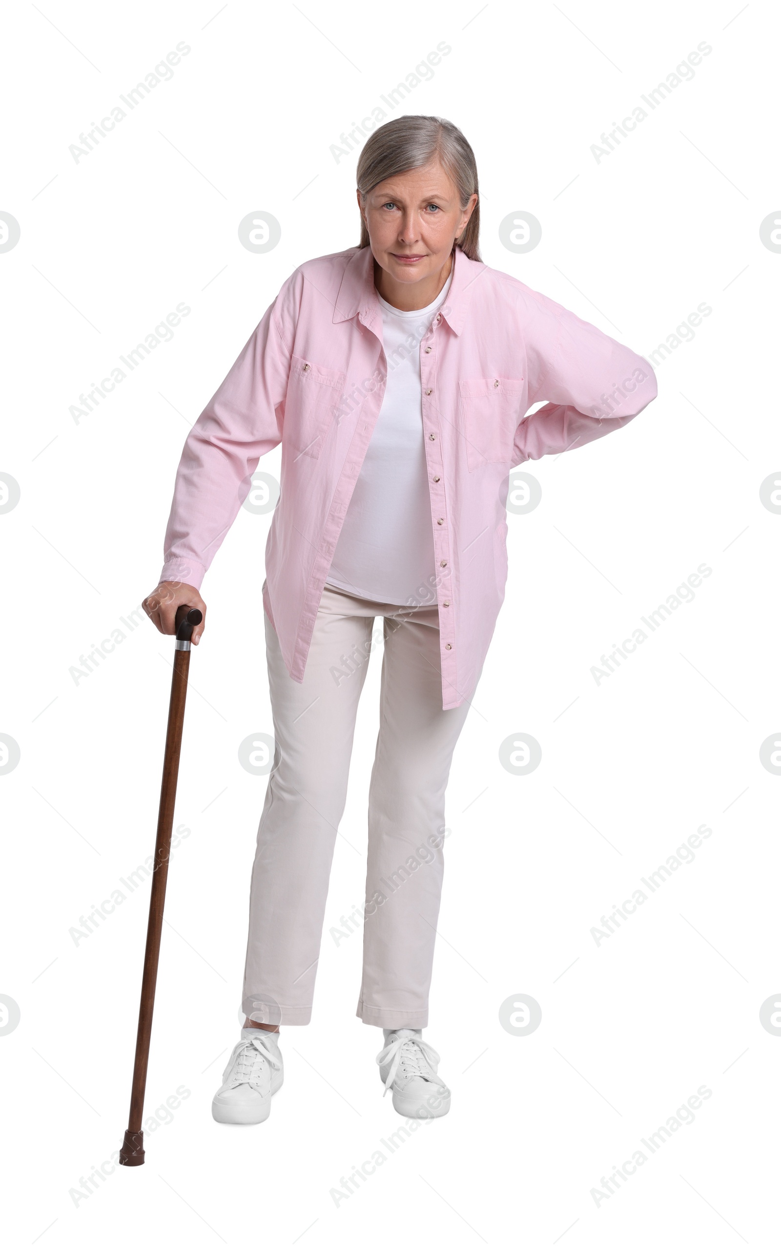 Photo of Senior woman with walking cane suffering from back pain on white background