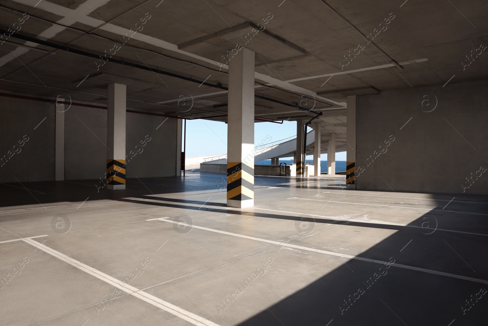 Photo of Empty open car parking near sea on sunny day