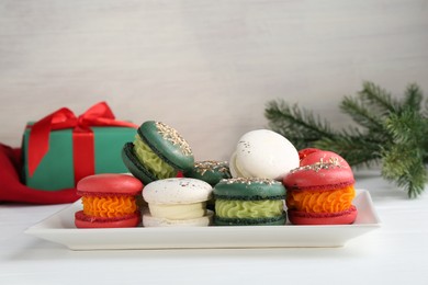 Photo of Beautifully decorated Christmas macarons and festive decor on white table