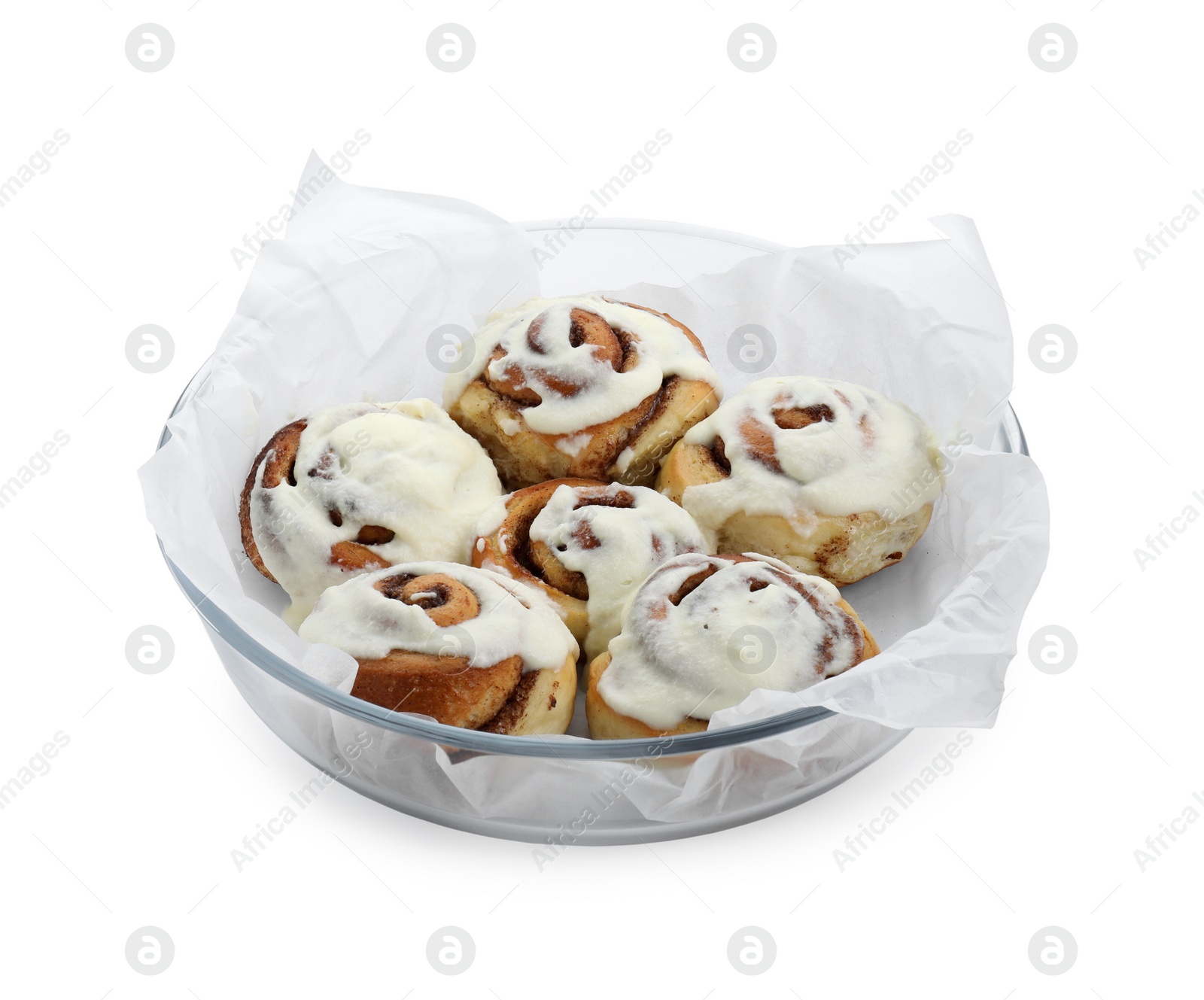 Photo of Tasty cinnamon rolls with cream in baking dish isolated on white