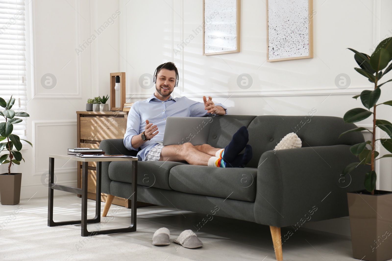 Photo of Businessman in underwear pretending to wear formal clothes during video call at home