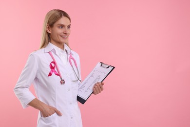 Photo of Doctor with pink ribbon, clipboard and stethoscope on color background, space for text. Breast cancer awareness
