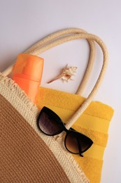 Photo of Flat lay composition with sunscreen and beach accessories on white background