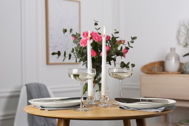 Photo of Romantic table setting with candles and flowers