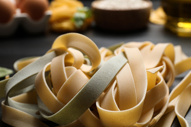 Photo of Closeup view of fresh raw tagliatelle pasta