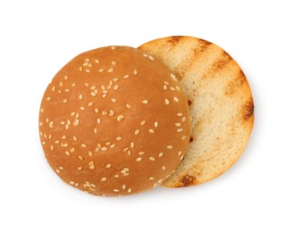 Photo of Halves of grilled burger bun isolated on white, top view