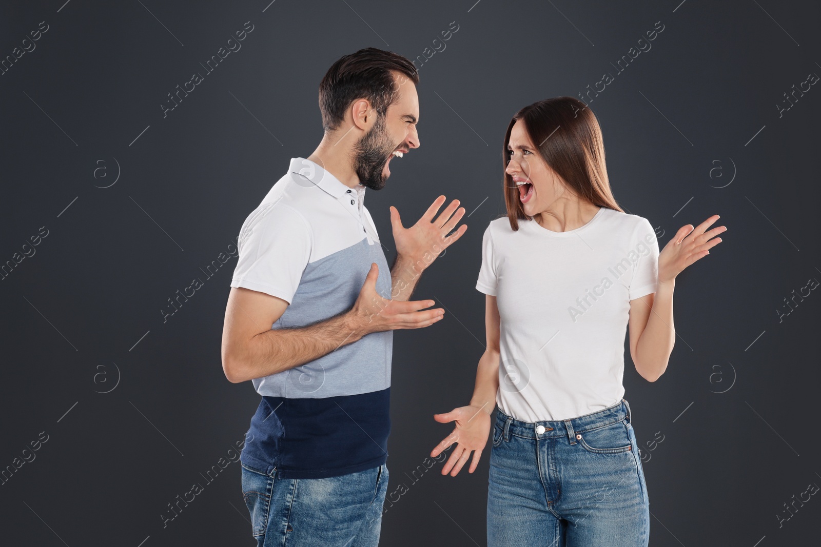 Photo of Couple quarreling on black background. Relationship problems