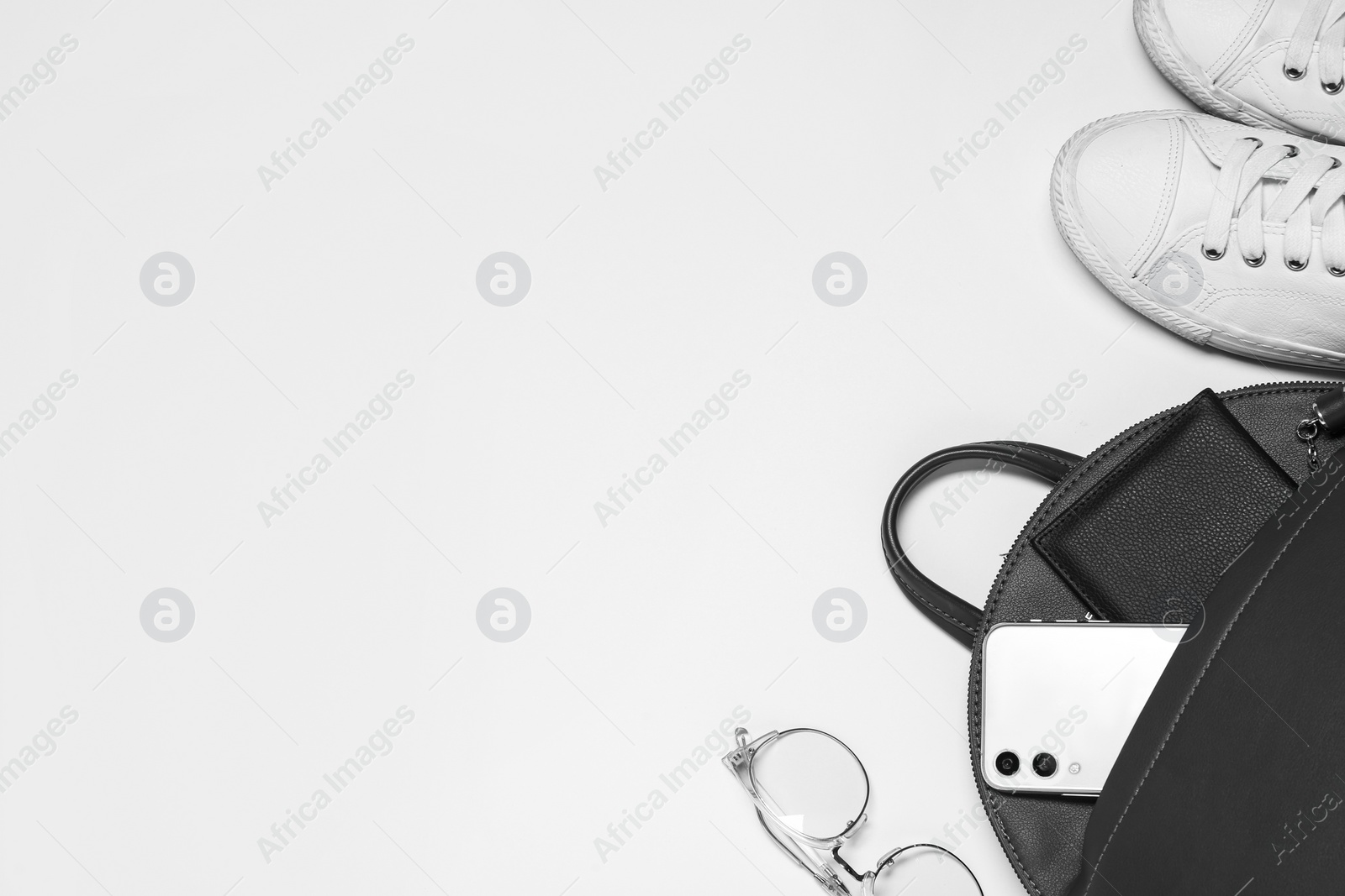 Photo of Stylish casual backpack and sneakers on white background, top view