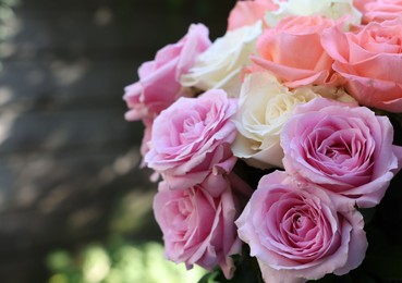 Photo of Beautiful bouquet of aromatic roses outdoors, closeup