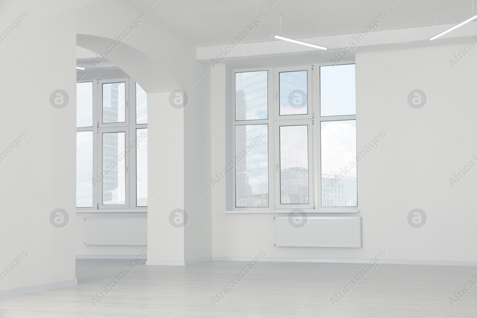 Photo of Modern office room with white walls and windows. Interior design