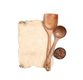 Photo of Old cookbook page, spices and wooden utensils on white background, top view. Space for text