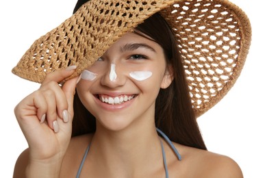 Photo of Teenage girl with sun protection cream on her face against white background