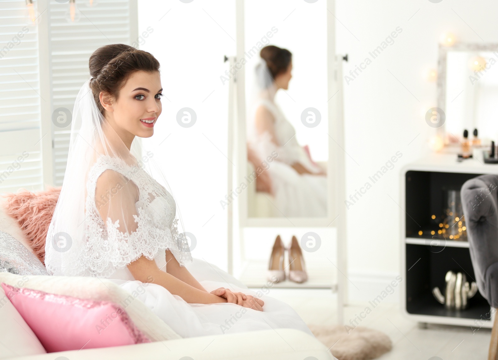 Photo of Beautiful young bride with makeup created by professional artist indoors