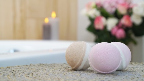 Photo of Colorful bath bombs on wicker mat in bathroom. Space for text