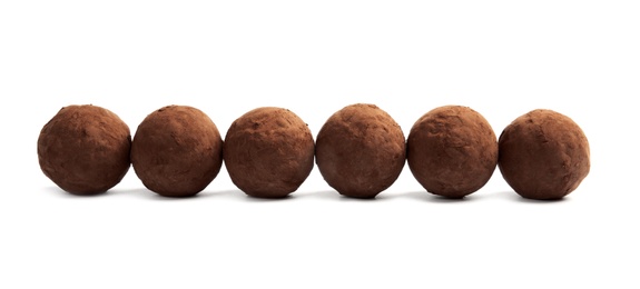 Delicious raw chocolate truffles on white background