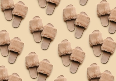 Soft slippers on beige background, top view. Pattern design 