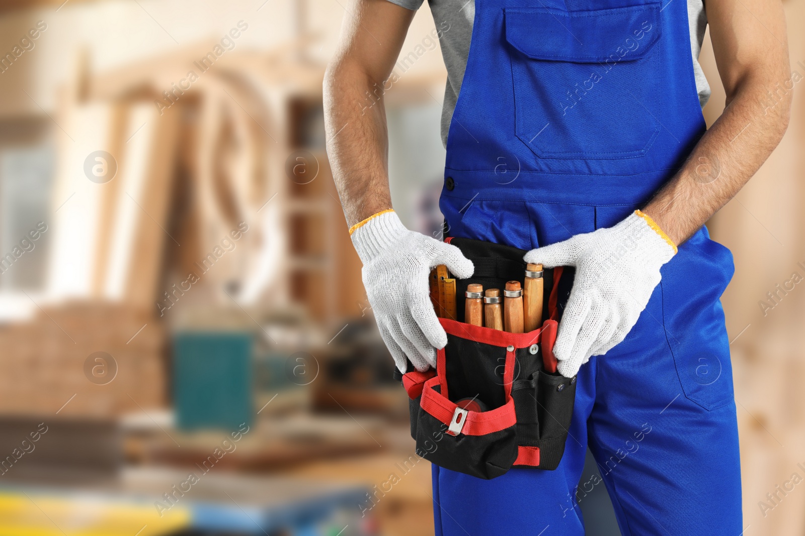 Image of Carpenter with tool belt in workshop, closeup