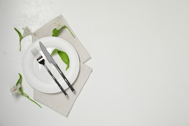 Photo of Stylish setting with elegant cutlery on white table, top view. Space for text