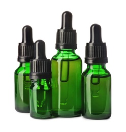 Photo of Cosmetic bottles of essential oils on white background