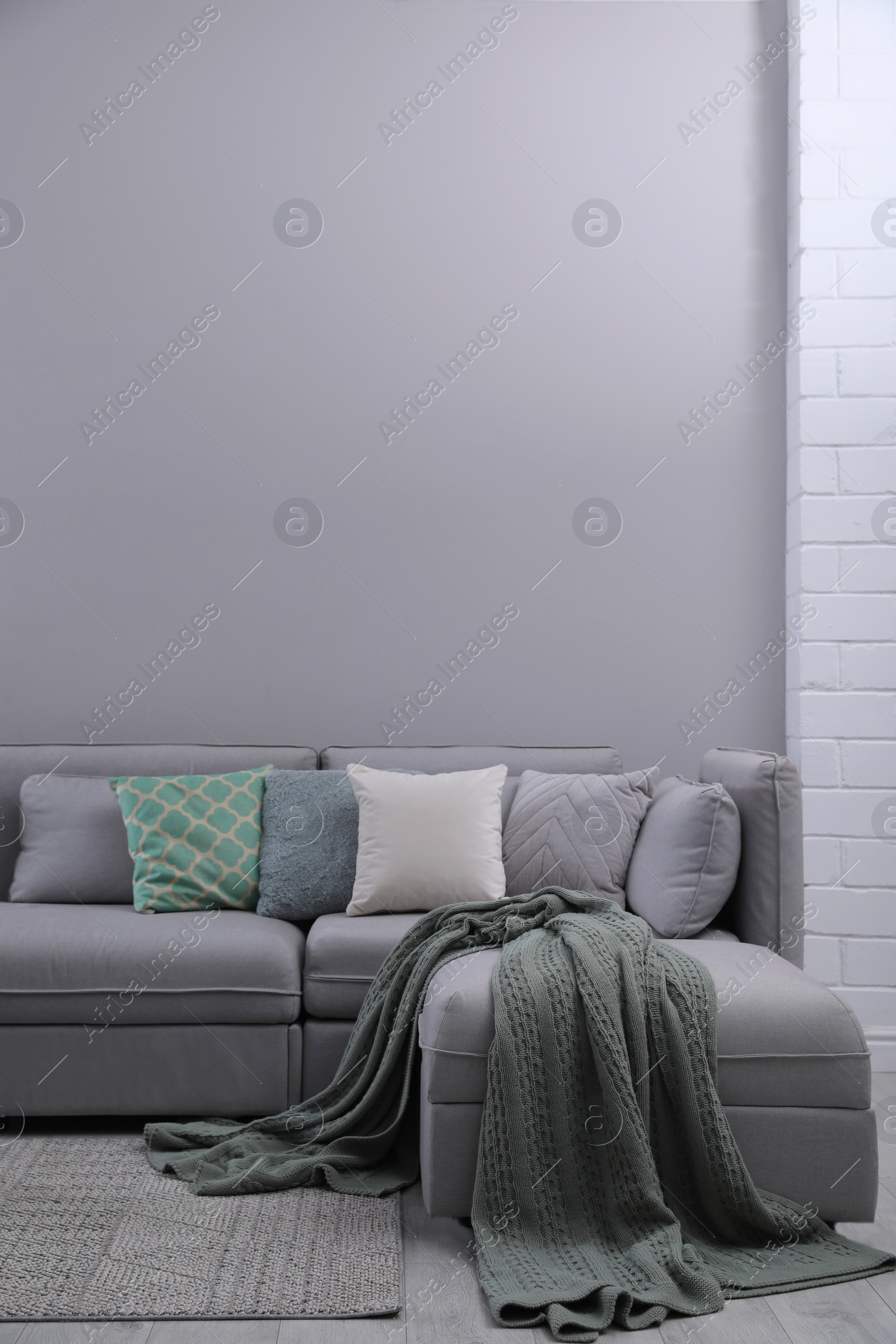 Photo of Large grey sofa in living room. Interior design