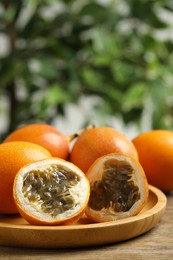 Delicious ripe granadillas on wooden table, closeup