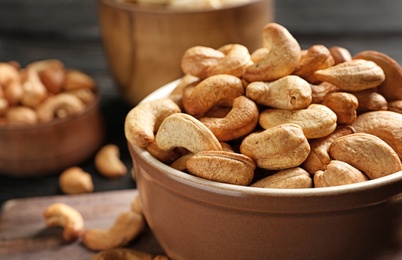 Bowl with cashew nuts on table, closeup