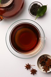Photo of Flat lay composition with aromatic tea and anise stars on white table