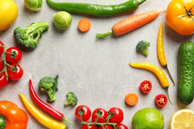 Flat lay composition with fresh vegetables and fruits on grey background
