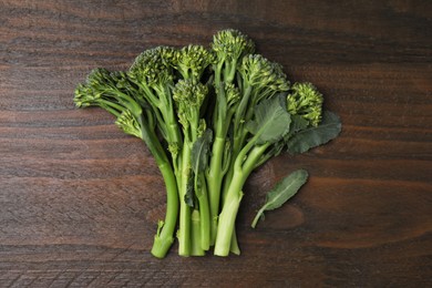 Fresh raw broccolini on wooden table, flat lay. Healthy food