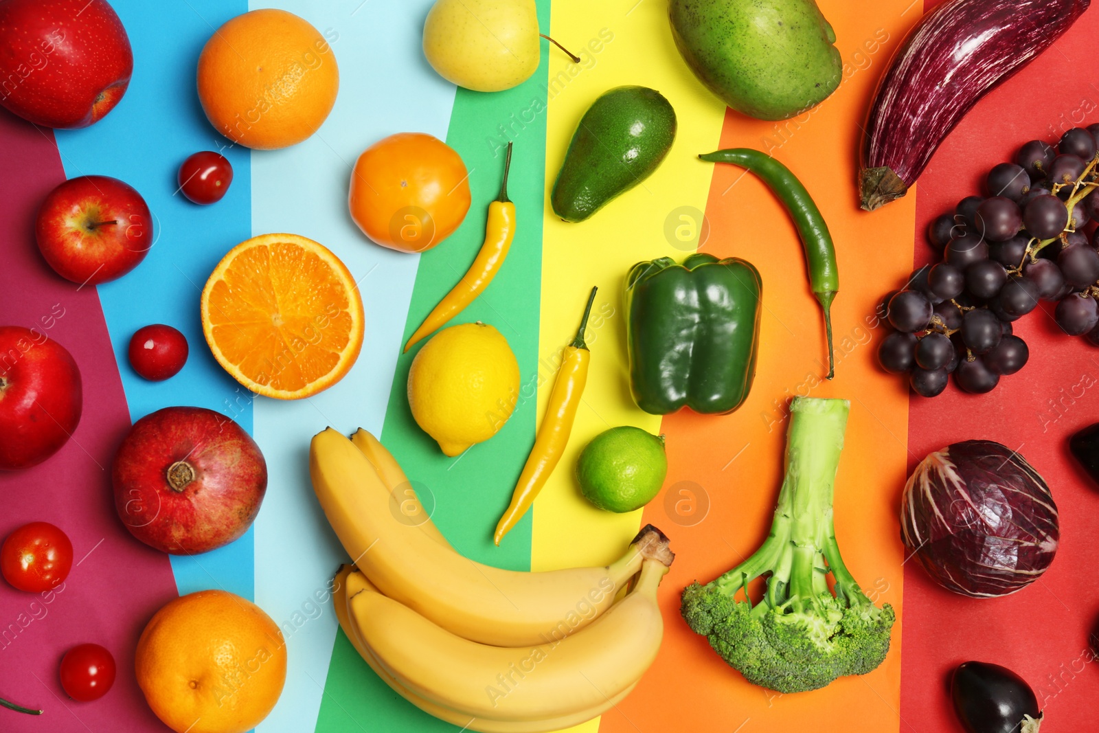 Photo of Rainbow composition with fresh vegetables and fruits on color background, flat lay