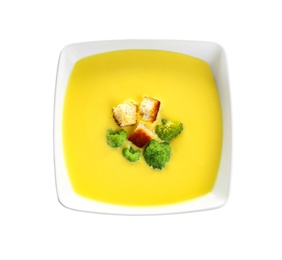 Photo of Bowl of cheese cream soup with broccoli and croutons on white background, top view