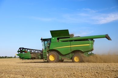 Modern combine harvester working in agricultural field