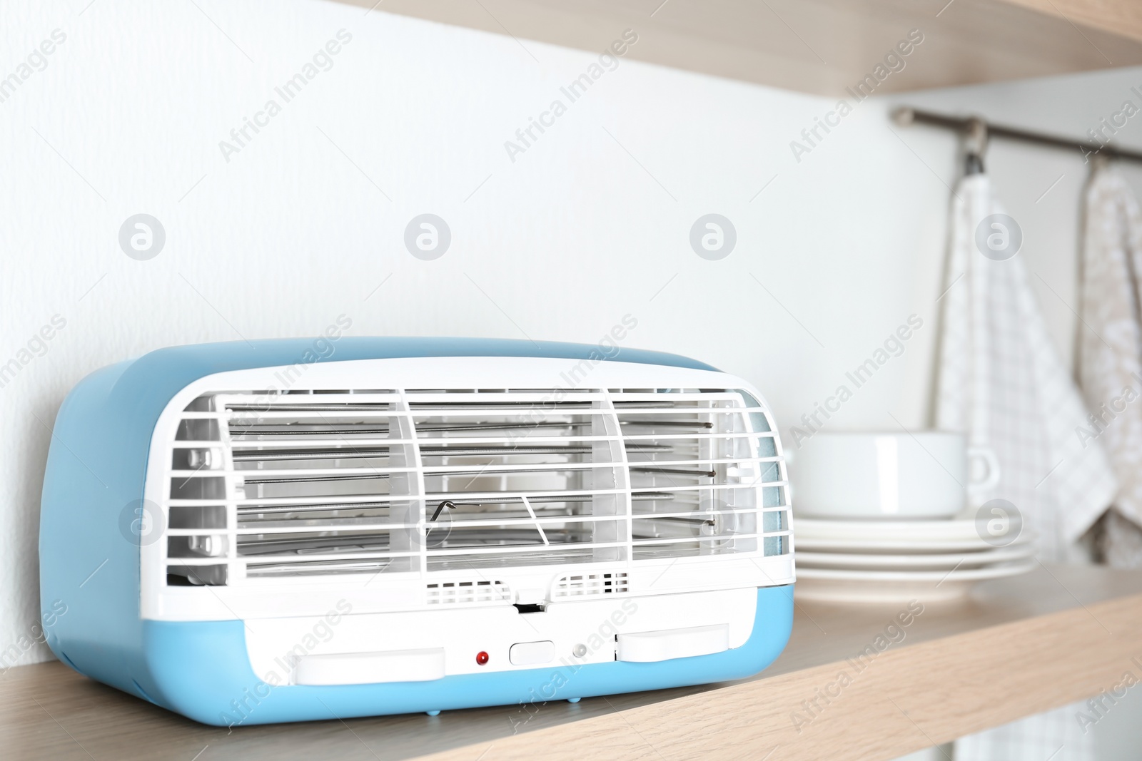 Photo of Modern air purifier on wooden shelf, closeup