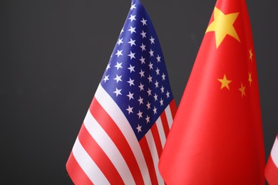 Closeup view of USA and China flags on dark background. International relations