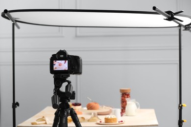 Photo of Professional camera with picture of beautiful composition on display in photo studio. Food stylist
