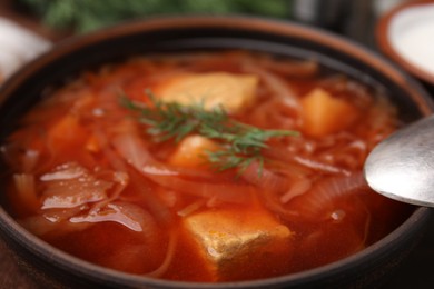 Photo of Delicious borscht with meat and vegetables in bowl, closeup