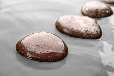 Wet stones in water, closeup. Zen lifestyle