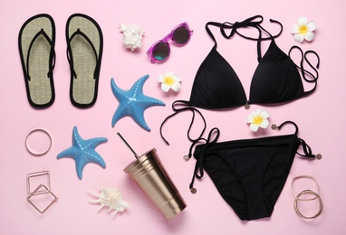 Set of stylish women's accessories and swimsuit on pink background, flat lay