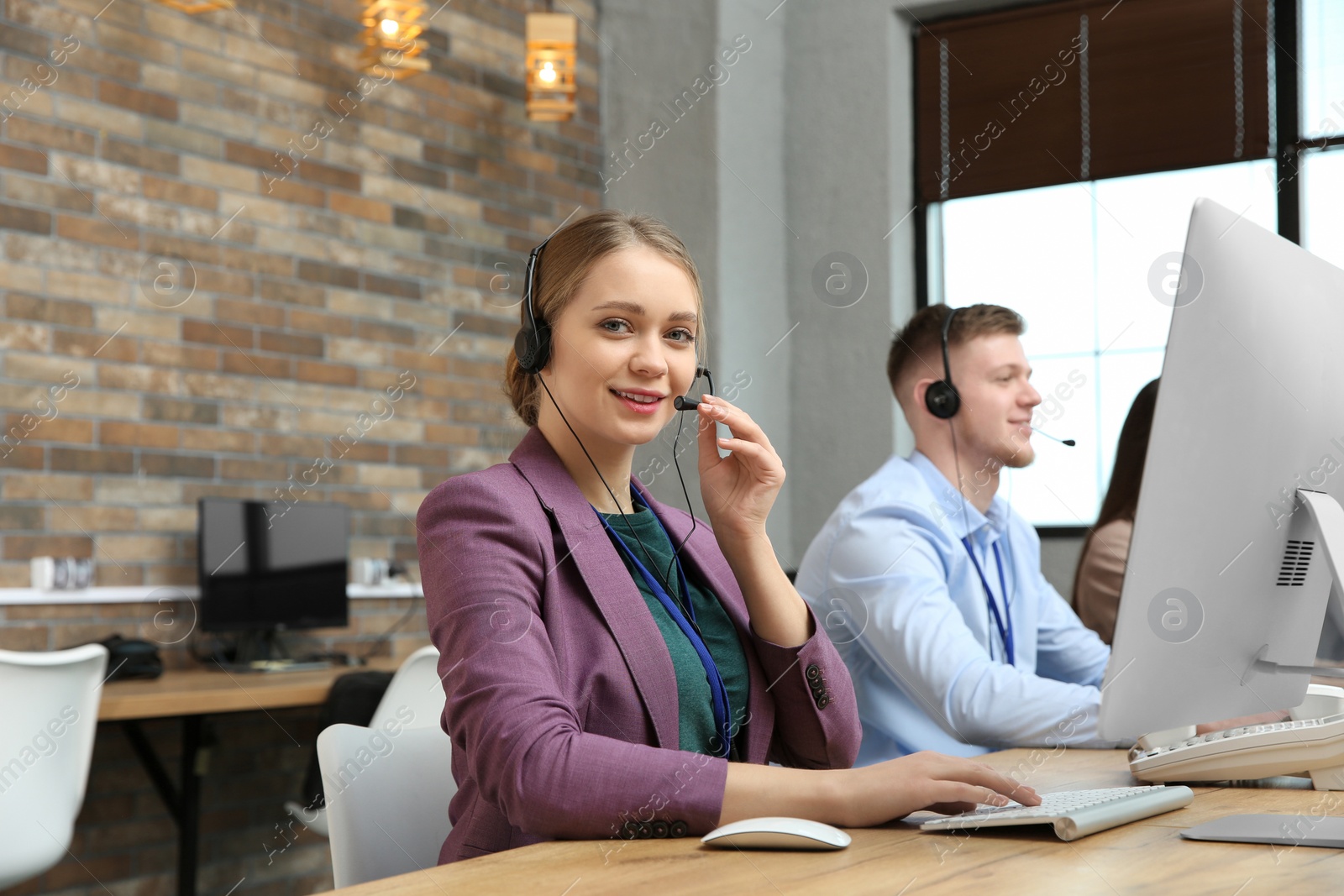 Photo of Technical support operator working with colleagues in office