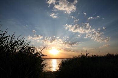 Picturesque view of beautiful sunrise on riverside. Morning sky