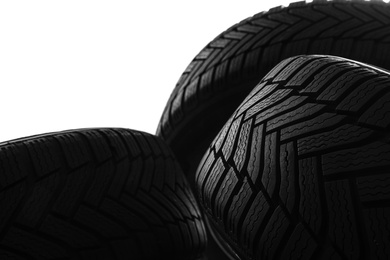 Photo of Pile of winter tires on white background, closeup