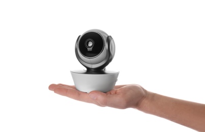 Photo of Woman holding baby camera on white background. CCTV equipment