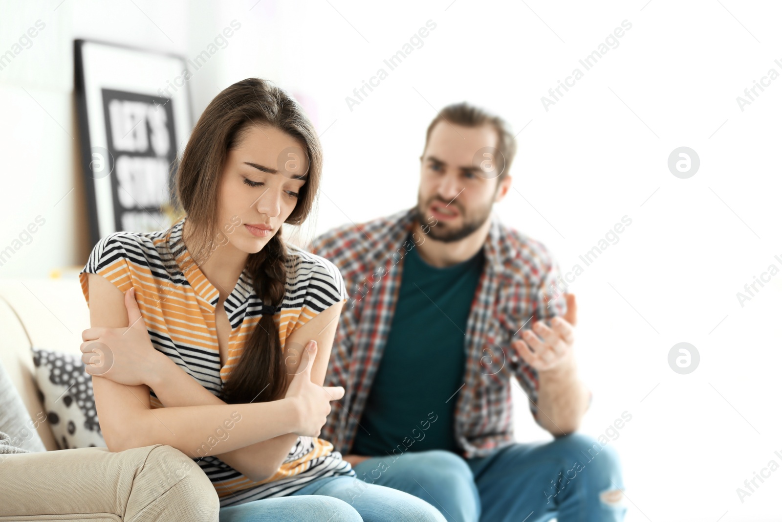 Photo of Young couple having argument in living room