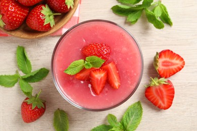 Delicious strawberry mousse with mint on white wooden table, flat lay