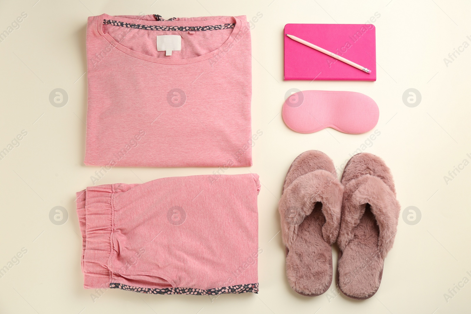 Photo of Flat lay composition with house slippers, sleeping mask and pajamas on light background