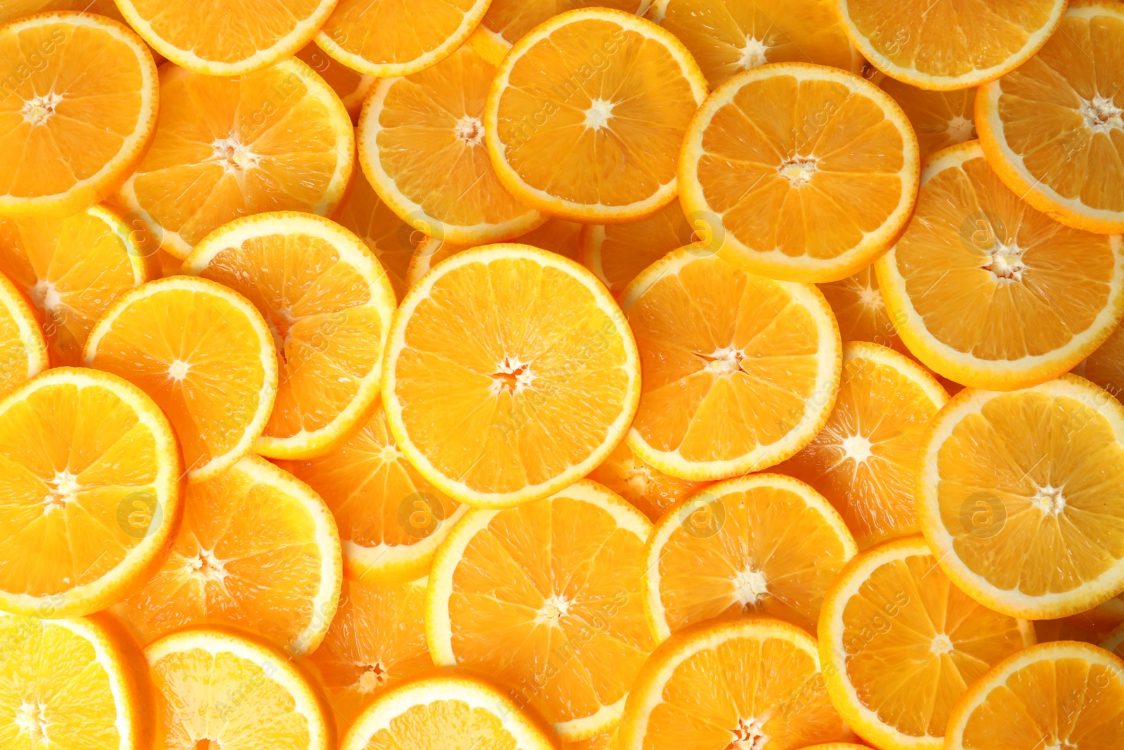 Photo of Many sliced fresh ripe oranges as background, top view