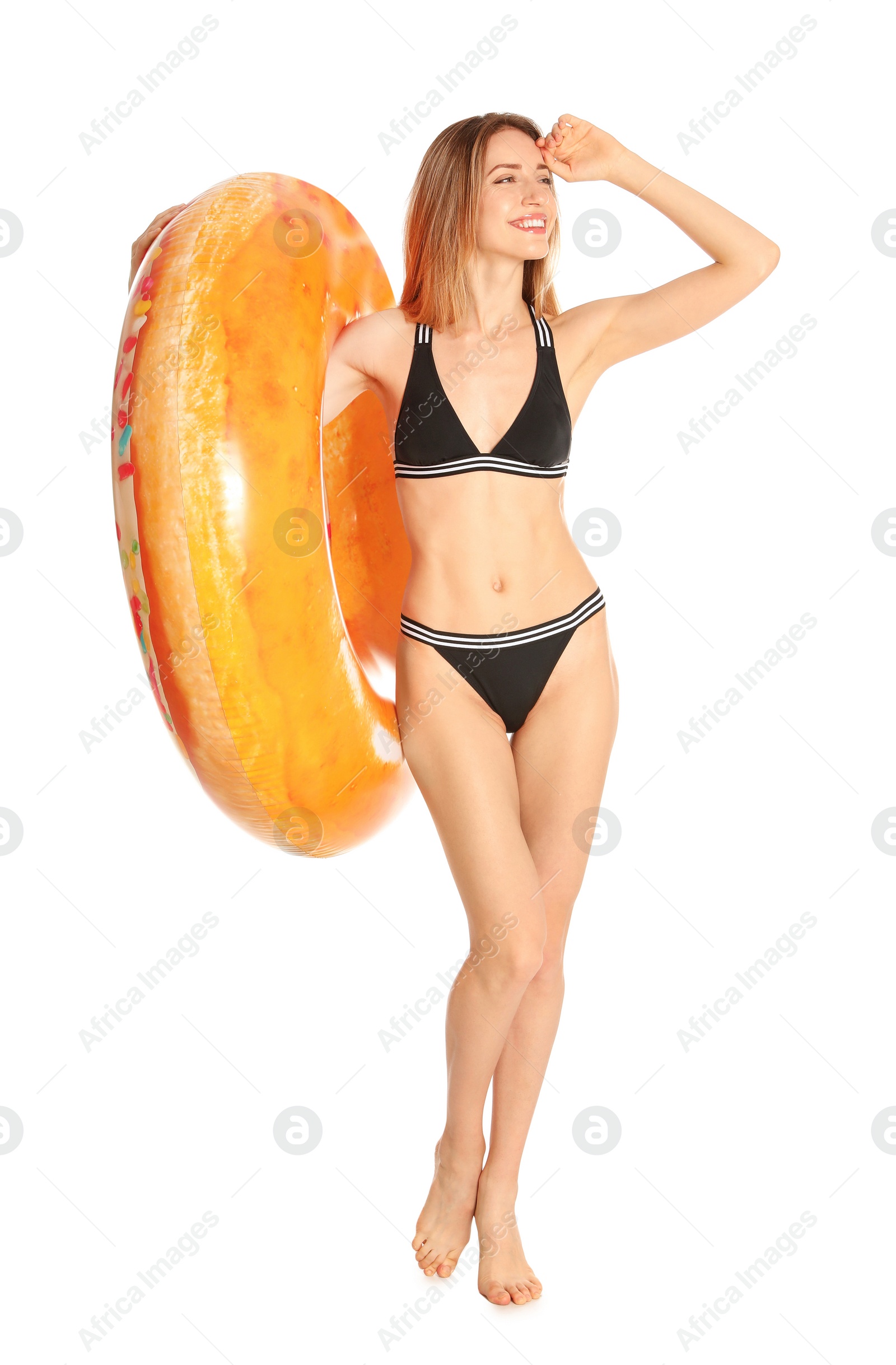 Photo of Beautiful young woman in stylish bikini with bright inflatable ring on white background