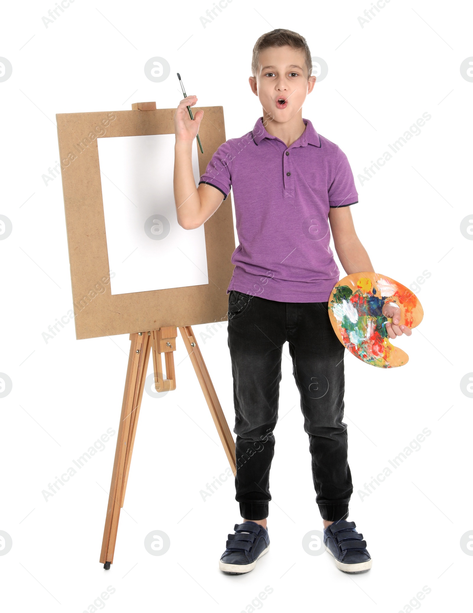 Photo of Child painting picture on easel against white background. Space for text